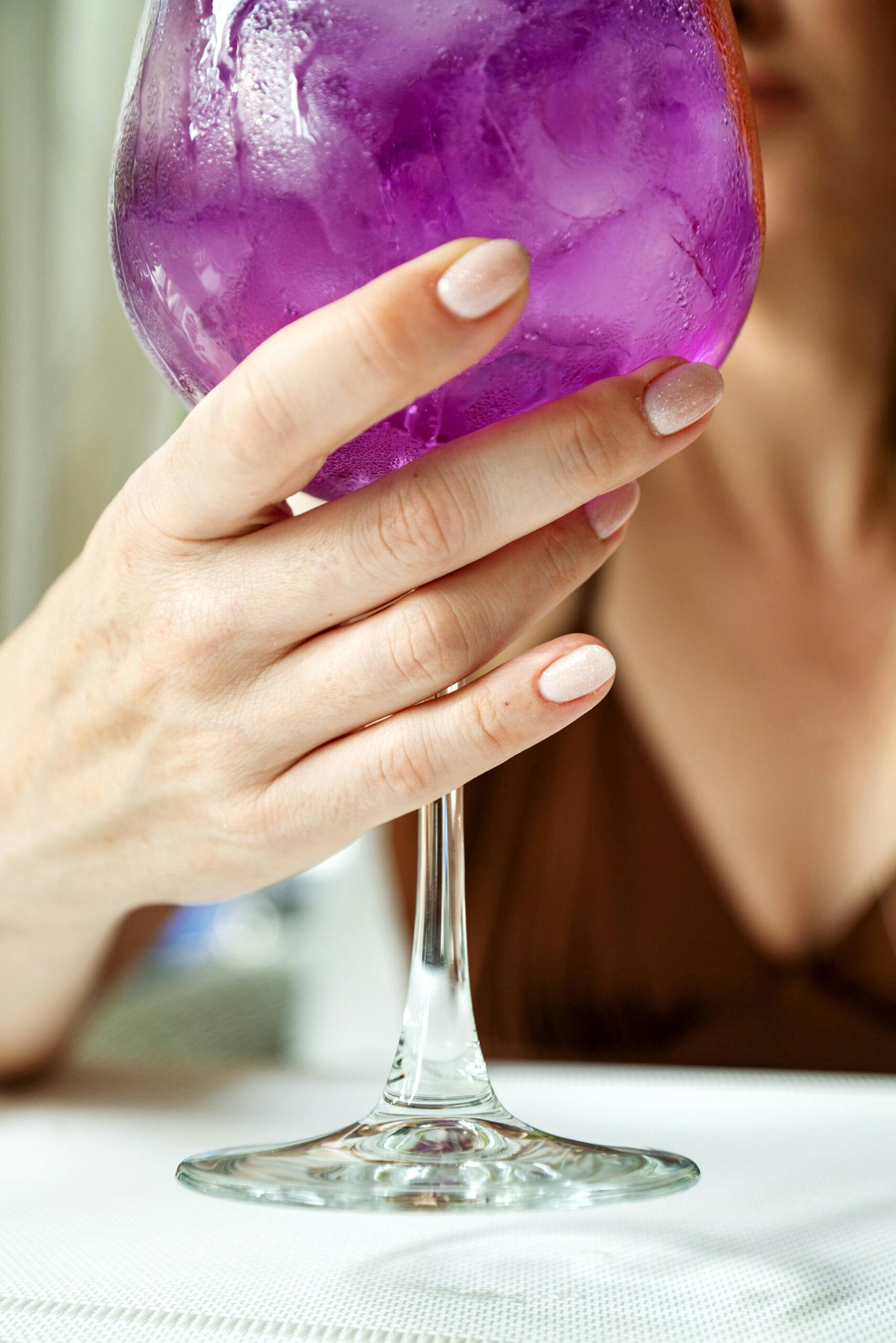 wine glass filled with purple drink