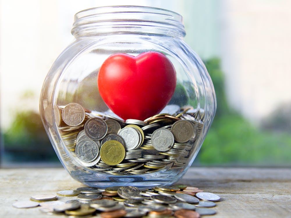 money change in jar with heart